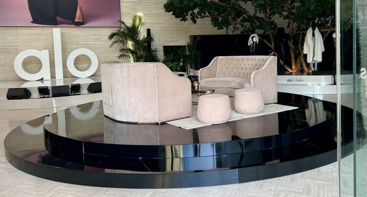 Circular and Round Stage Rental — Black mirrored round stage with lounge seating — Alo retail event installation