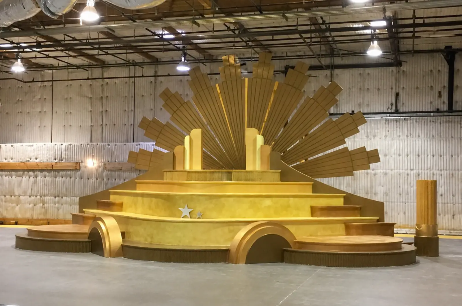 Customized Stages and Fabrication — Gold Art Deco sunburst stage with tiered platforms and rounded approach steps — built in our LA production facility