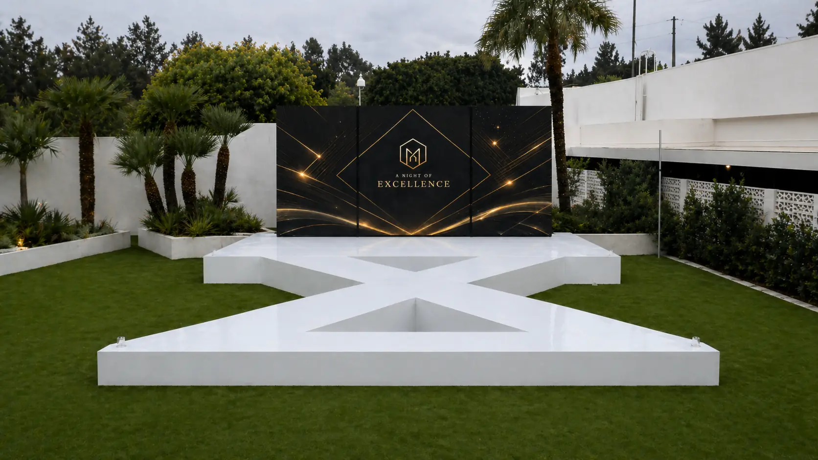 Customized Stages and Fabrication — White star-shaped platform with branded backdrop — outdoor 'A Night of Excellence' awards build