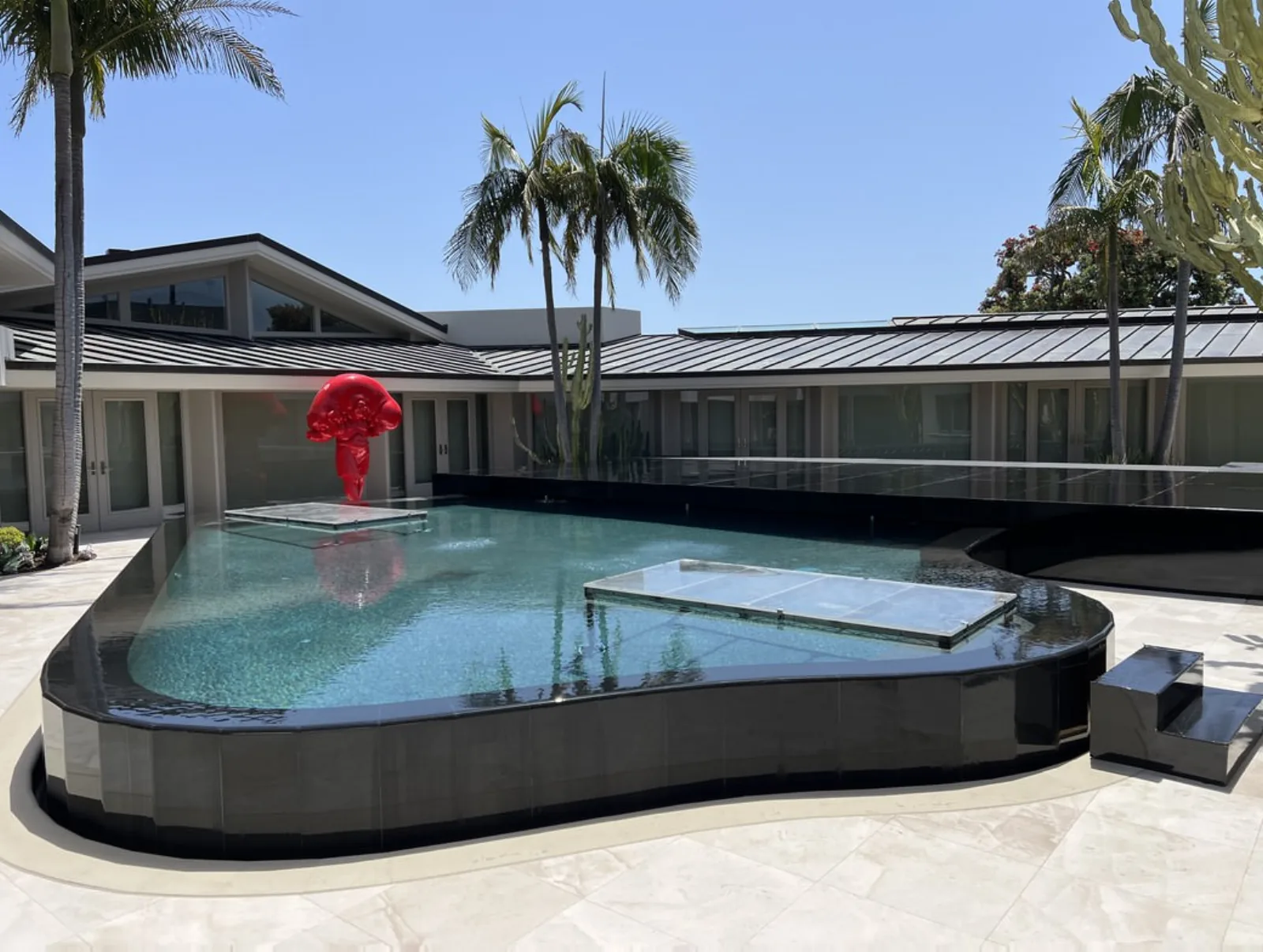 Pool Covers — Floating black-tile pool cover platforms — luxury residence event