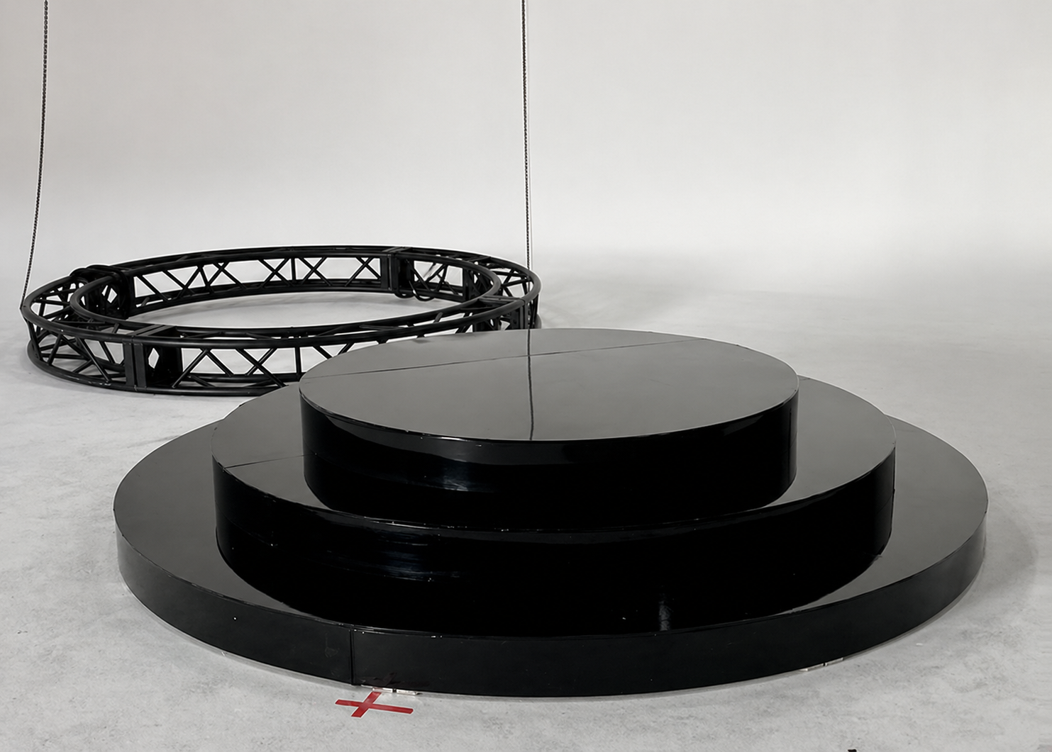 Circular and Round Stage Rental — Three-tier black circular stage pre-install — modular round platform ready for delivery