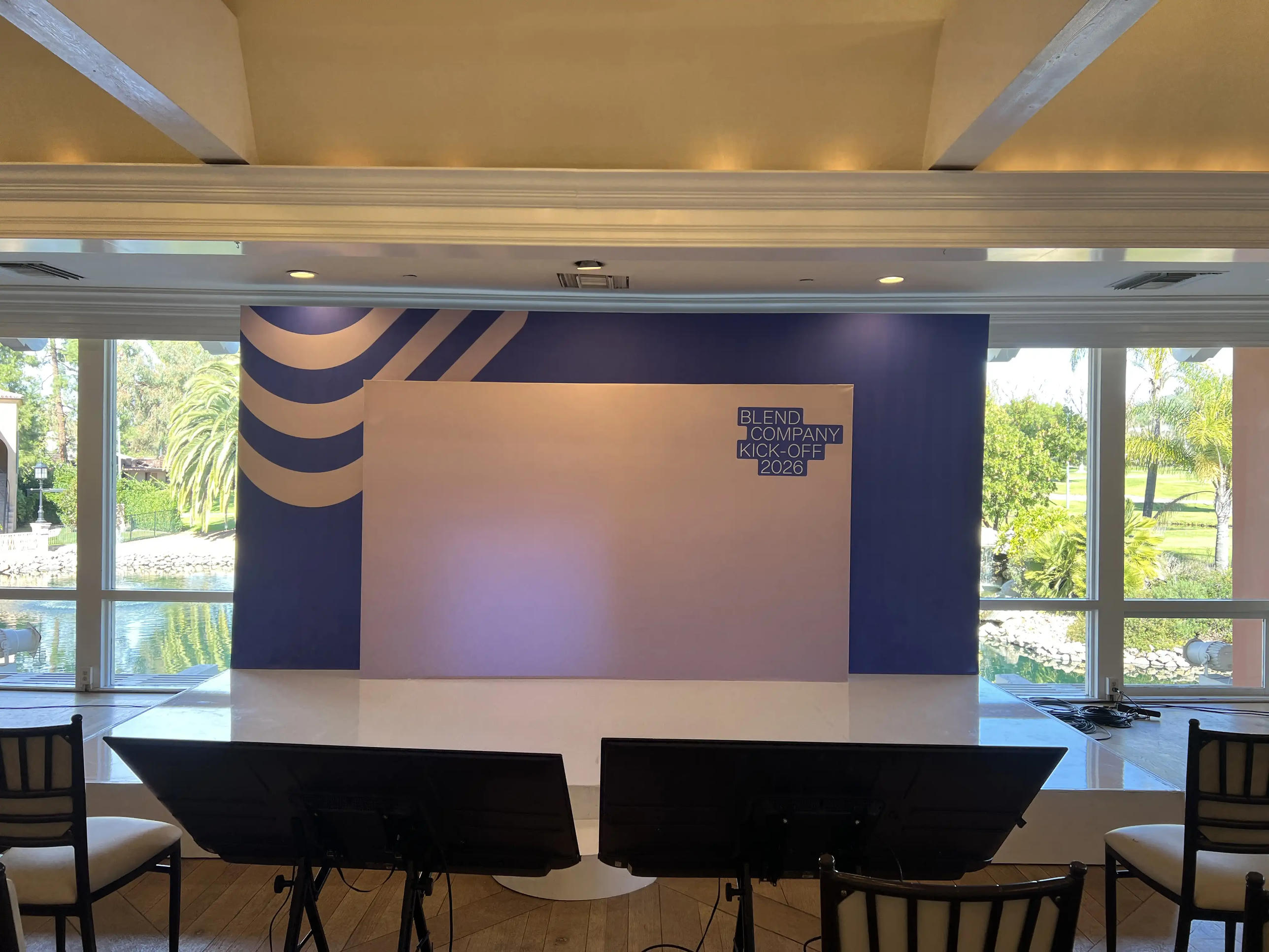 Layered flat backdrop with custom navy and white-pink panels — Blend company kickoff