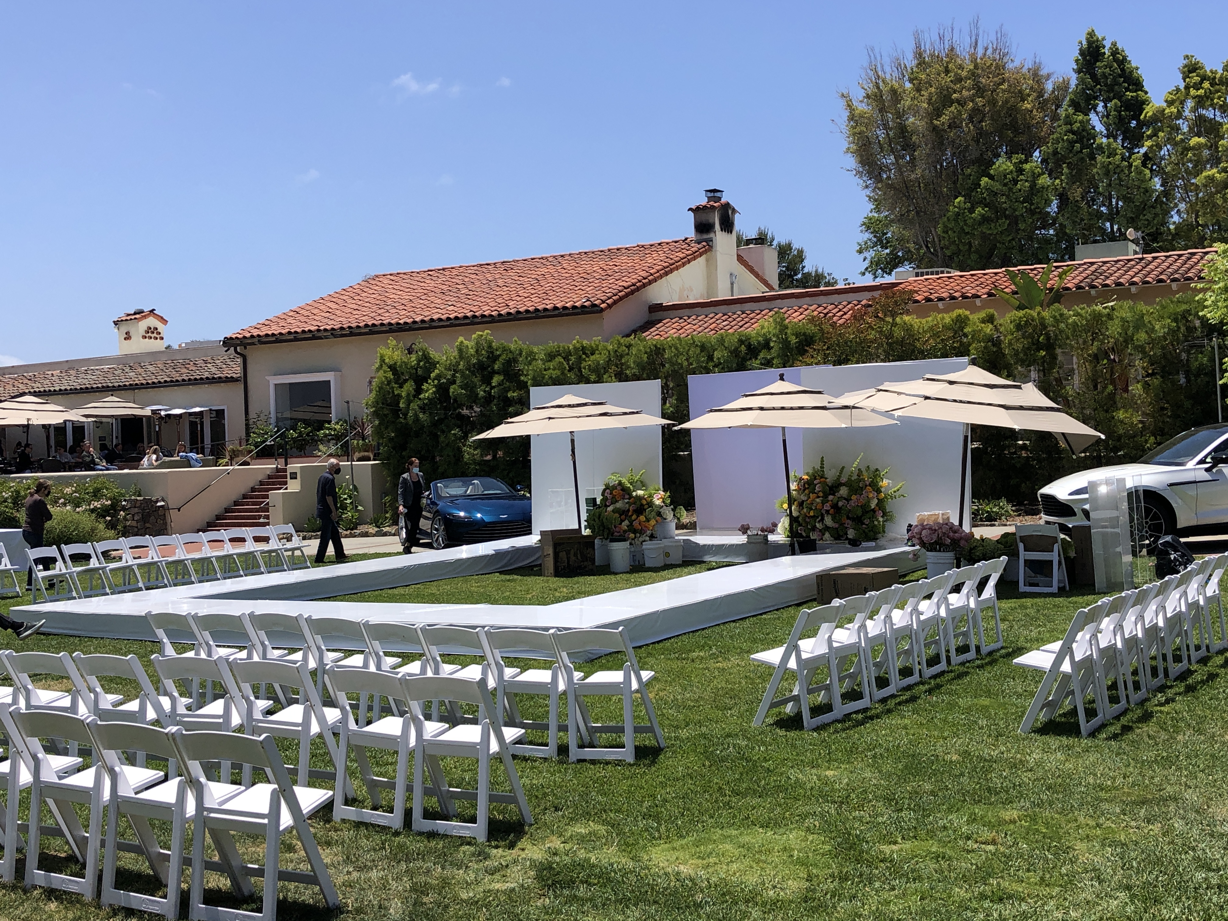 Stage and Runaway Rental — White modular runway and ceremony platform with guest seating — garden event install